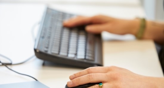 Hands using a keyboard and mouse)