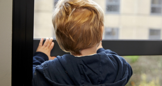 A child looking out of a window)