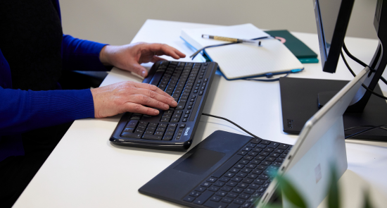 Someone typing on a computer keyboard)